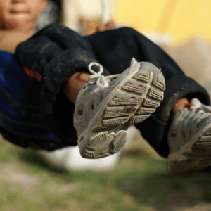 child swinging close up on sneakers
