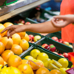 arm reaching for produce in grocery store