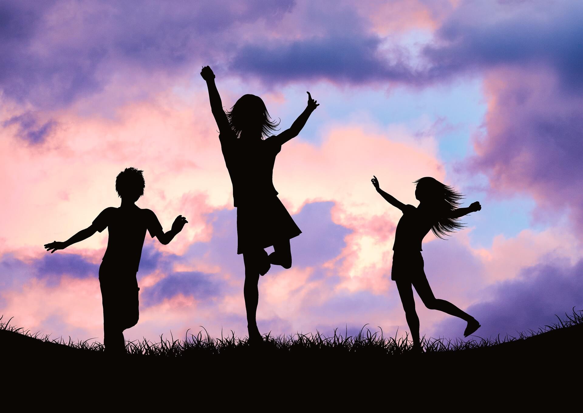 children jumping sunset